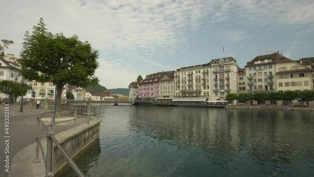 Establishing shot of Lucerne Old Town picturesque buildings next to Reuss River at daytime, Switzerland Establishing shot of Lucerne Old Town picturesque buildings next to Reuss River at daytime, Switzerland