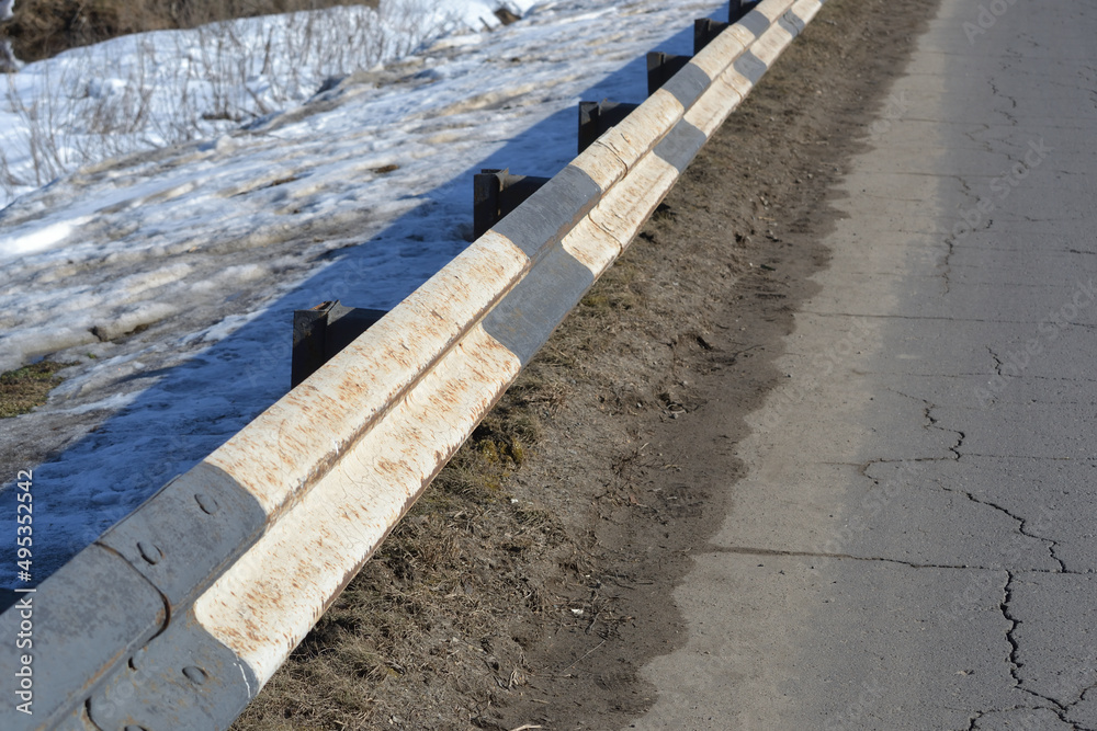 Dirty metal road barrier barrier type. Roads and traffic safety.
