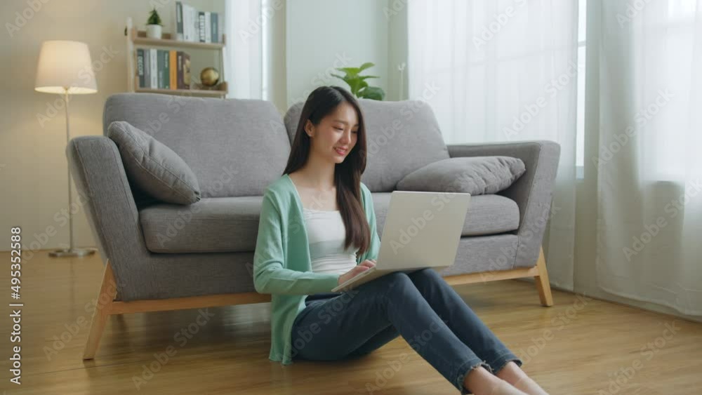 Young Asian woman using laptop computer for online working, studying, learning chatting in social media at home. Young Asian woman using laptop computer for online working, studying, learning chatting in social media at home.