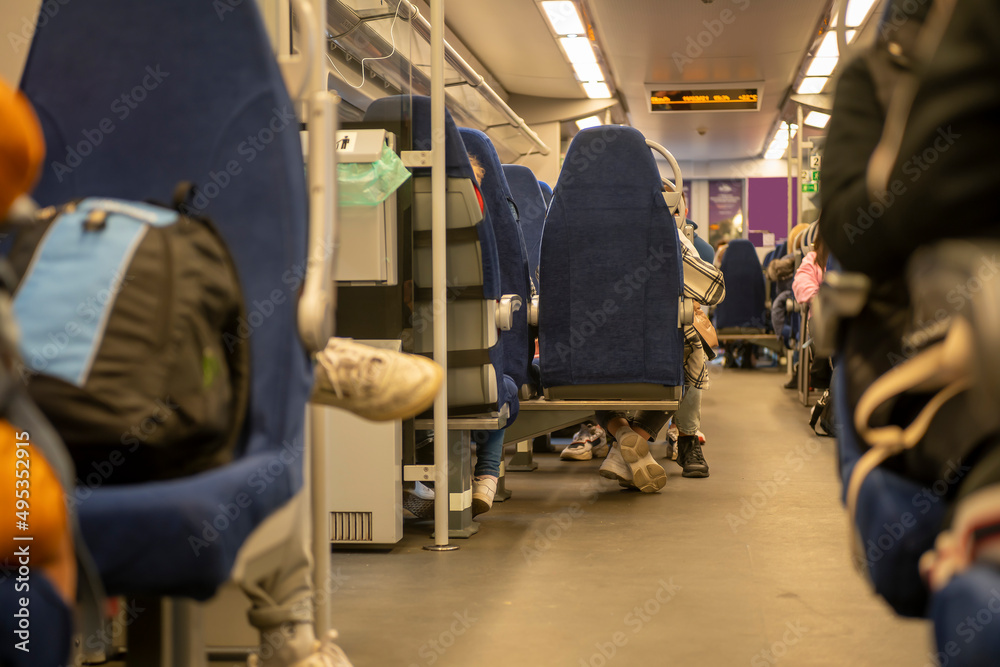 Salon of a railway car with passenger blue seats. Salon of a railway car with passenger blue seats.