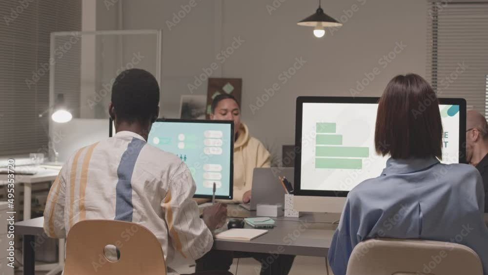 Video Stock Medium slowmo of four diverse employees sitting in front of ...