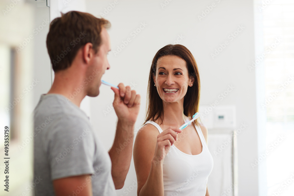Gotta look after our winning smiles. Shot of a mature couple brushing their teeth together in the bathroom.