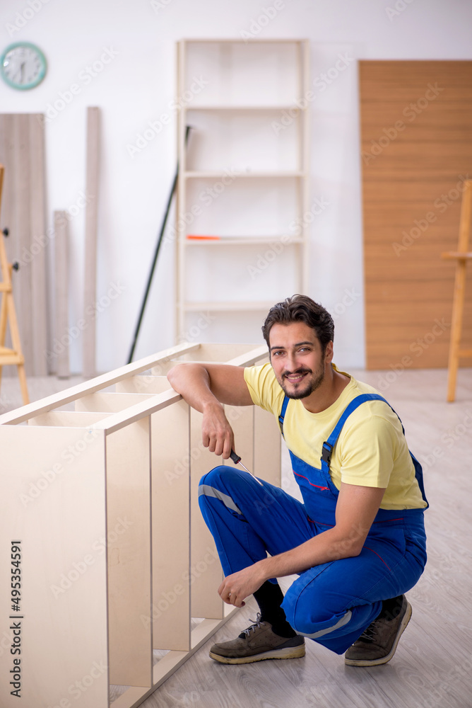 Young male carpenter working at home