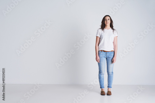 Stand for what is right even if it is alone. Studio shot of a beautiful young woman standing against a grey background.