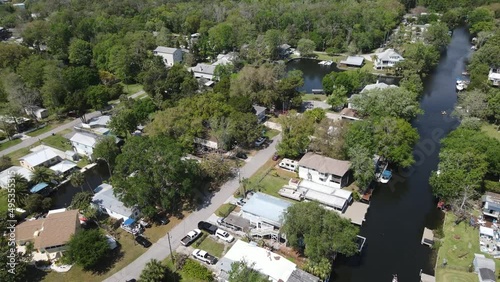 spinning aerial of a community with canals flowing into the Weeki Wachee River in Florida photo