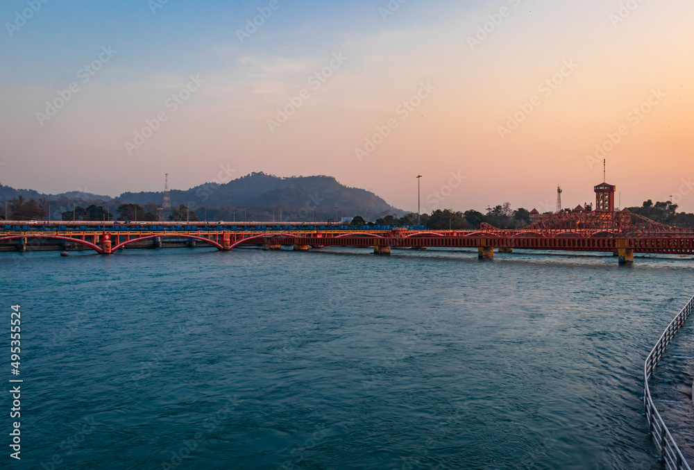 isolated iron bridge over ganges river with colorful sky at evening