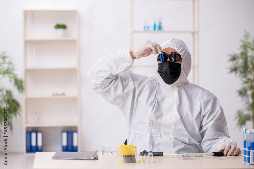 Young male chemist working at the lab during pandemic Young male chemist working at the lab during pandemic