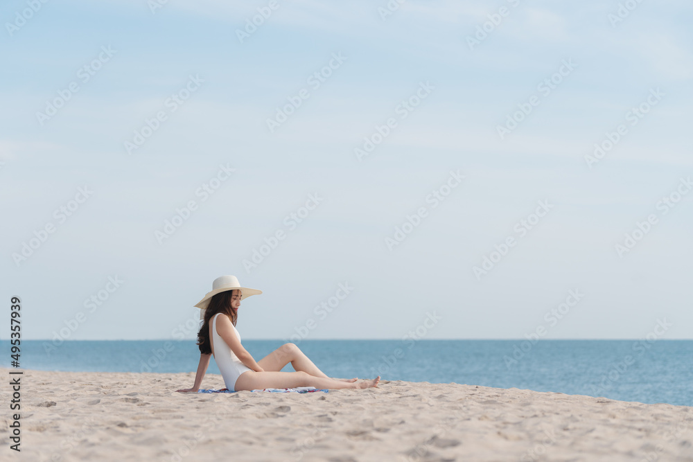 Summer vacation on the beach, Young woman relaxing on the beach with sea view Summer vacation on the beach, Young woman relaxing on the beach with sea view