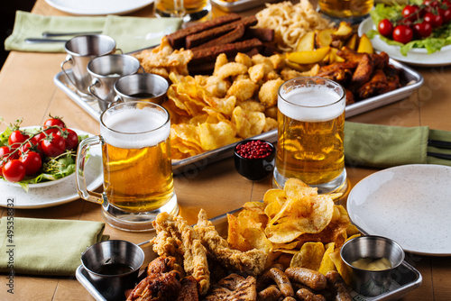 Table set with beer and salty snacks in a pub