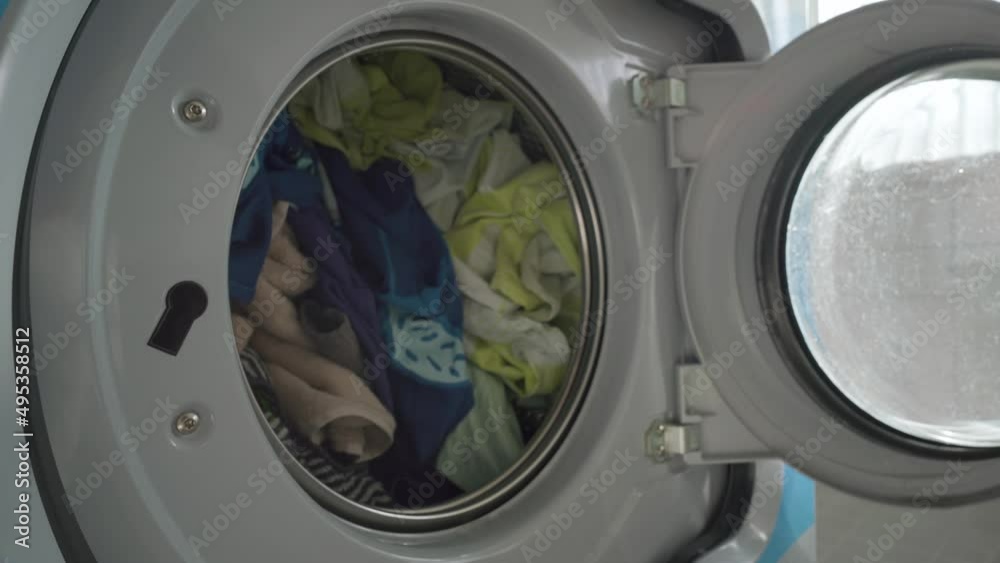 Man opening and closing a washing machine door. Close up Man opening and closing a washing machine door. Close up