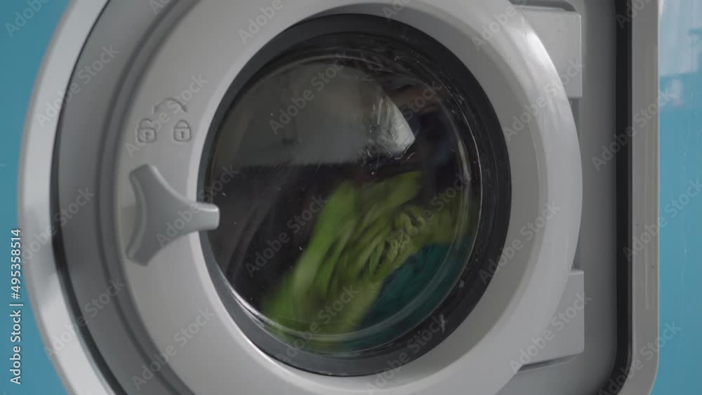 Laundry spinning in a washing machine. Close up Laundry spinning in a washing machine. Close up