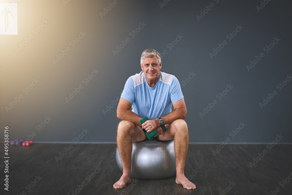 Fototapeta premium Im on the road to recovery. Full length portrait of a handsome senior man doing rehabilitative exercises.