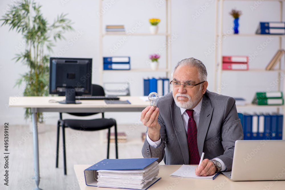 Old male employee in happy idea concept Old male employee in happy idea concept