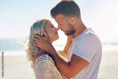 Some people are meant to fall in love. Cropped shot of n affectionate couple spending the day at the beach.