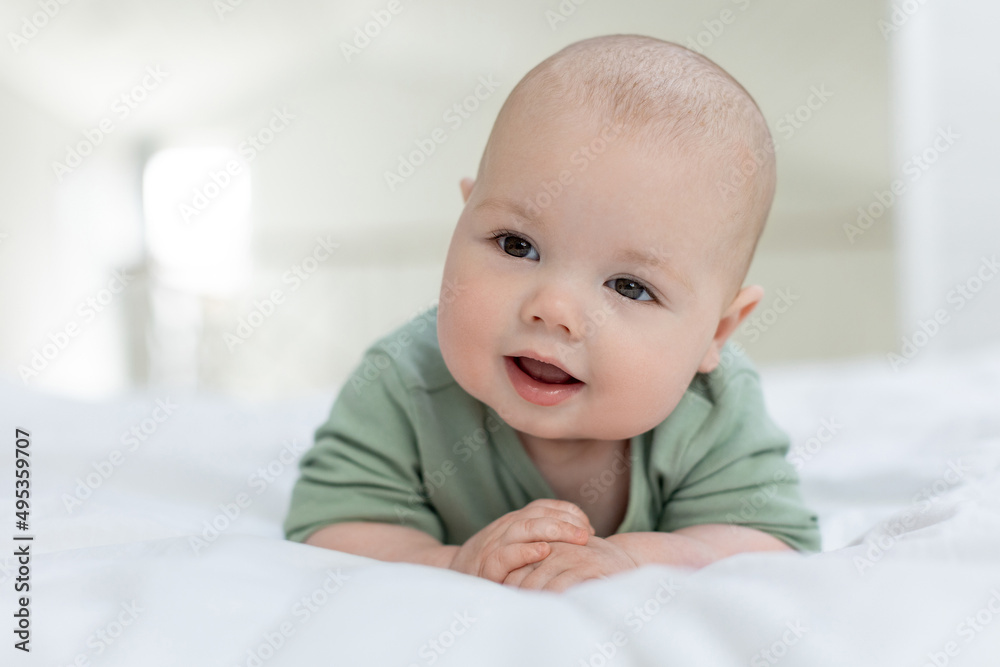 The baby lies on the bed. Little baby. High quality photo The baby lies on the bed. Little baby. High quality photo