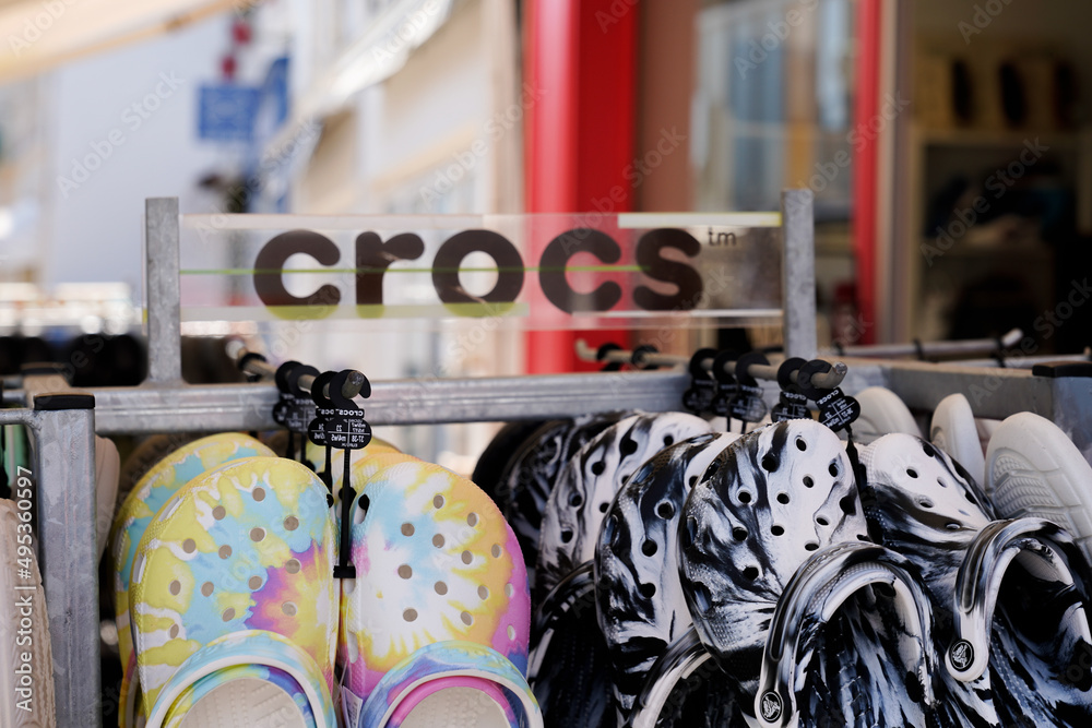 crocs text sign and logo brand front of American footwear company store  manufactured foam clog plastic shoes shop Stock Photo | Adobe Stock