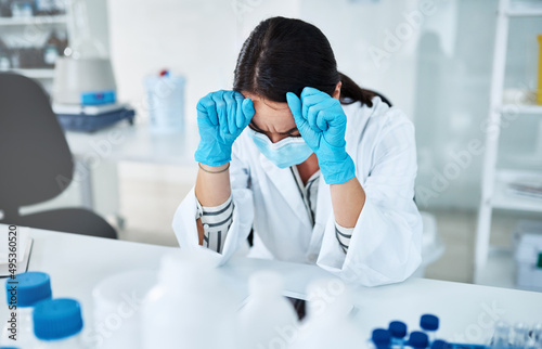 The solutions are becoming harder to find. Shot of a young scientist looking stressed out while working in a lab.