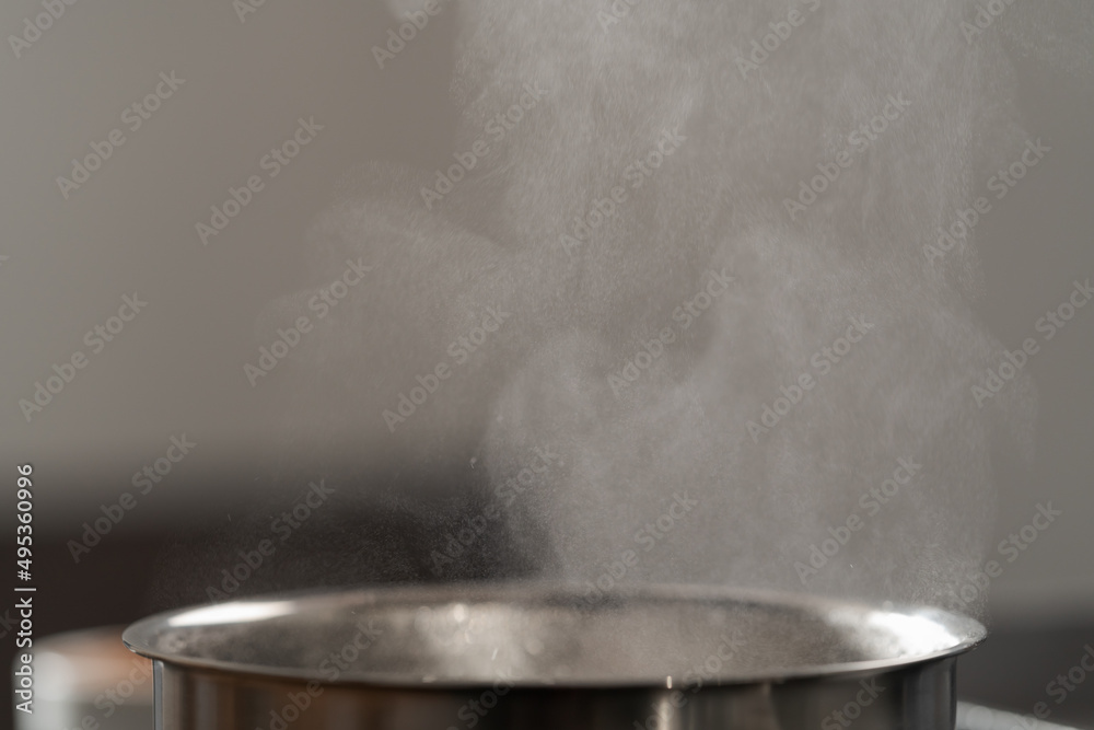Saicepan with hot boiling water closeup