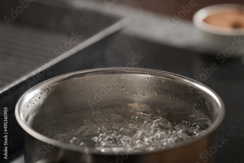 Saicepan with hot boiling water closeup