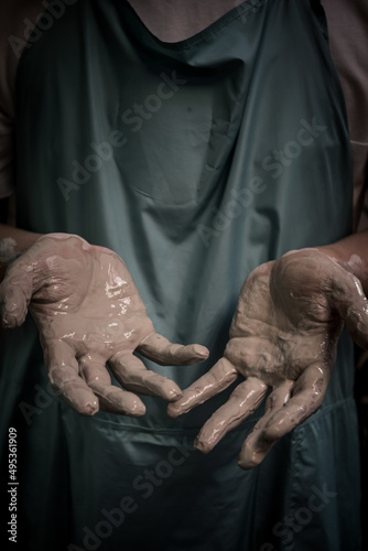 Hands in clay after working at the potter's wheel, close-up