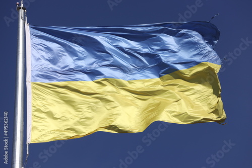 unconquered flag of Ukraine on sky background