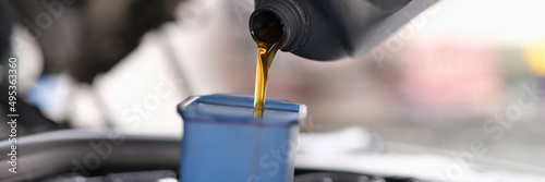Machine oil for a car is poured into a container