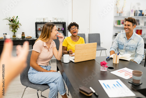 co-workers multiracial women sitting in a business meeting, agency workers meeting for new projects - focus on blonde woman -multi-racial, multi-age working group ffice - focus on African women photo