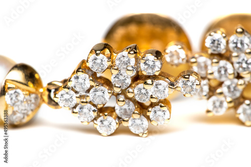 Close up shot of Indian style diamond earring on white background