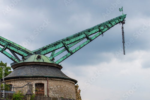 Green copper Vintage Old Crane by the Main river in the old part of town Würzburg on a sunny day in summer
