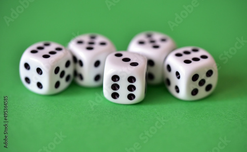 five dice on green