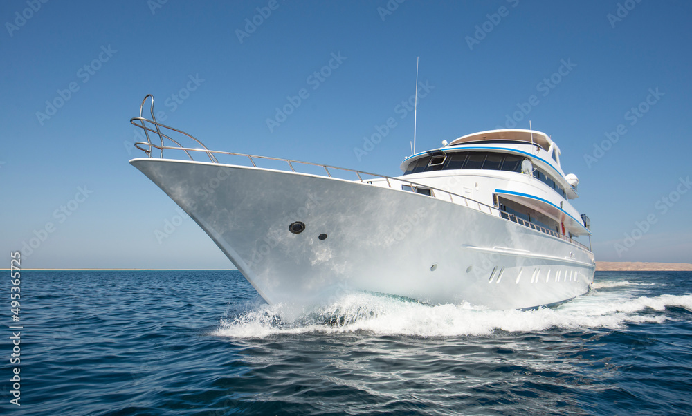 Luxury private motor yacht sailing at sea - obrazy, fototapety, plakaty 