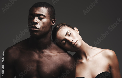 Love your skin. Shot of a beautiful couple posing in a studio - gray background.