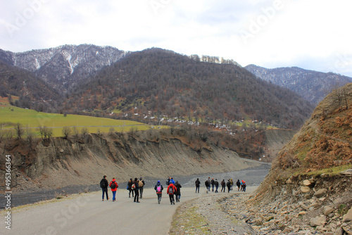 Tourists walking towards the beautiful mountains.