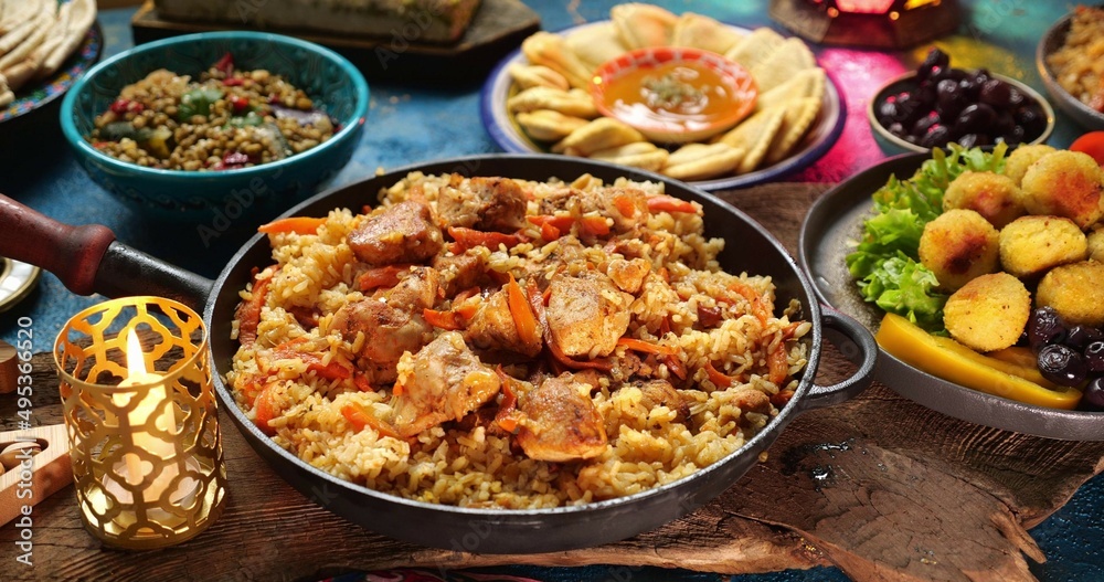 Traditional food of Ramadan. Pilaf plov or pilau is a rice dish, adding spices and meat. Eid al-Fitr Table Setting, halal meals
