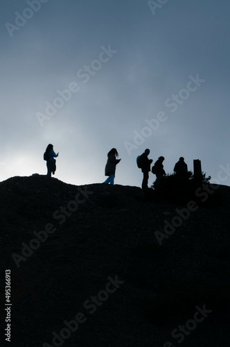 silhouettes of people on the hill