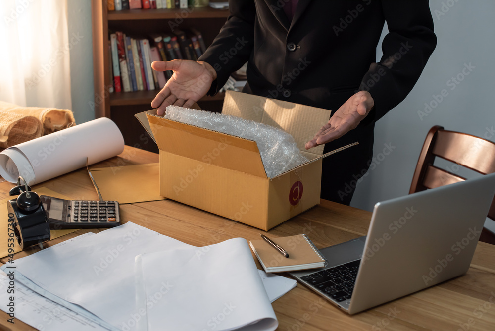 Closeup of man packing parcels with sticky tape at warehouse. Packing products for delivery, shipping service. Delivery concept for private companies delivery with care, Craft present box. Online shop