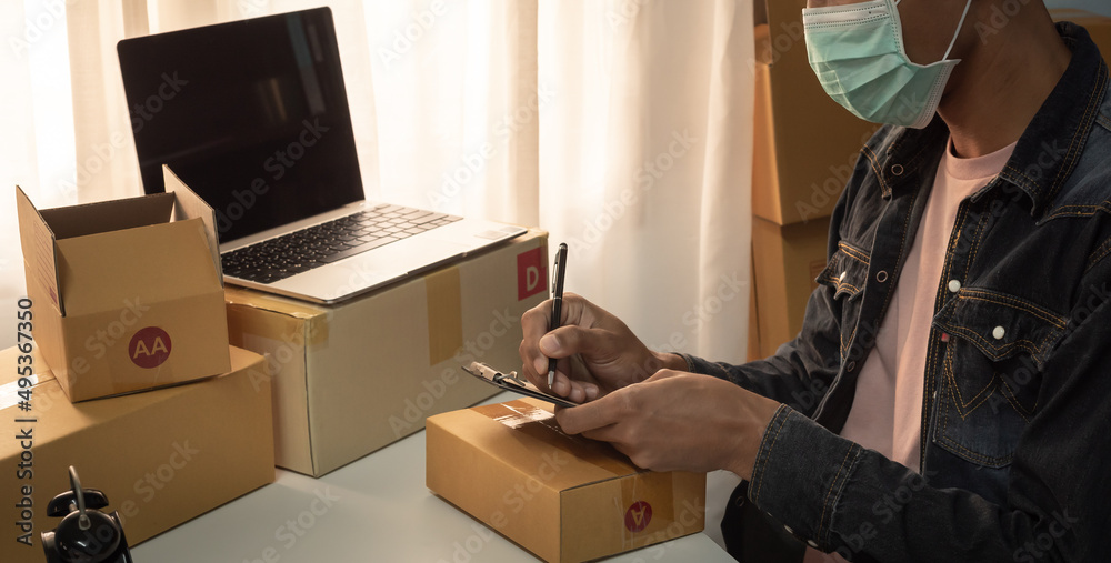 Small business owner packing in the card box at workplace. Cropped shot of man preparing a parcel for delivery at online selling business office. Ecommerce drop shipping shipment service concept. Small business owner packing in the card box at workplace. Cropped shot of man preparing a parcel for delivery at online selling business office. Ecommerce drop shipping shipment service concept.
