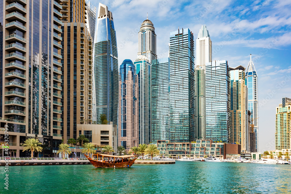 Obraz premium Dubai marina and tourist traditional boat in UAE