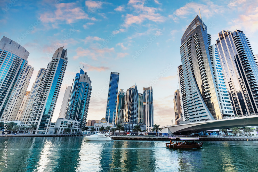 Fototapeta premium Dubai marina and tourist boat at sunset.