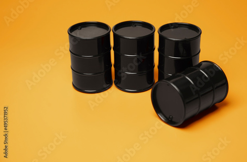 Black barrels against orange background photo