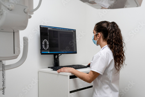 Nurse working on computer in maxillofacial clinic photo