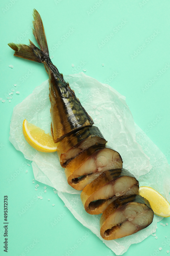 Concept of tasty food with smoked mackerel on mint background