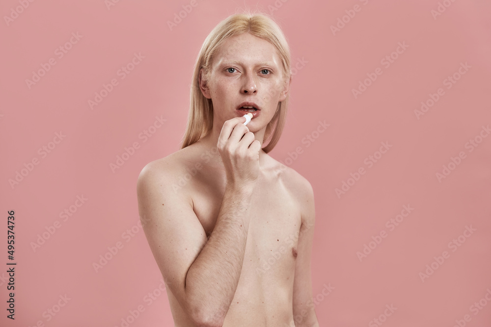 Front view of caucasian guy with hygienic lipstick Front view of caucasian guy with hygienic lipstick