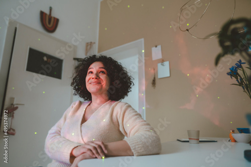 Smiling woman looking at astro light effects in room