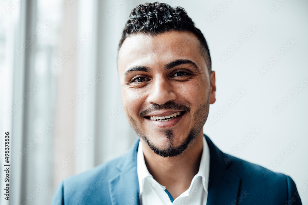 Happy businessman with black hair in office Happy businessman with black hair in office
