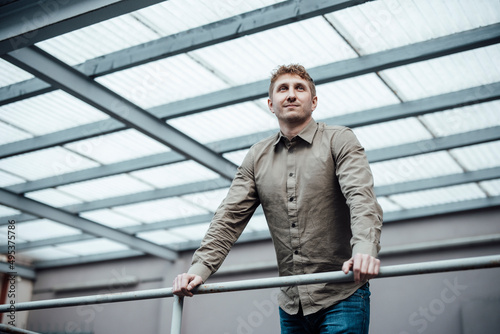 Wallpaper Mural Thoughtful businessman leaning on railing at work place Torontodigital.ca