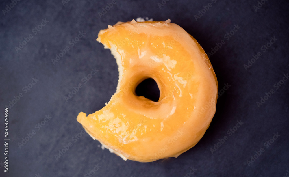 classic glazed donut.Flat lay donut on black plate.sweet doughnut