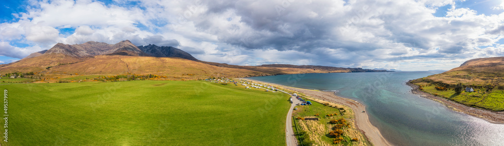 Scenic view of lake and Cuillin mountains under cloudy sky Scenic view of lake and Cuillin mountains under cloudy sky