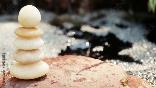 Photography The Balance Stones are stacked as pyramids in a soft natural bokeh background, representing the calm philosophical concept of Jainism's wellness