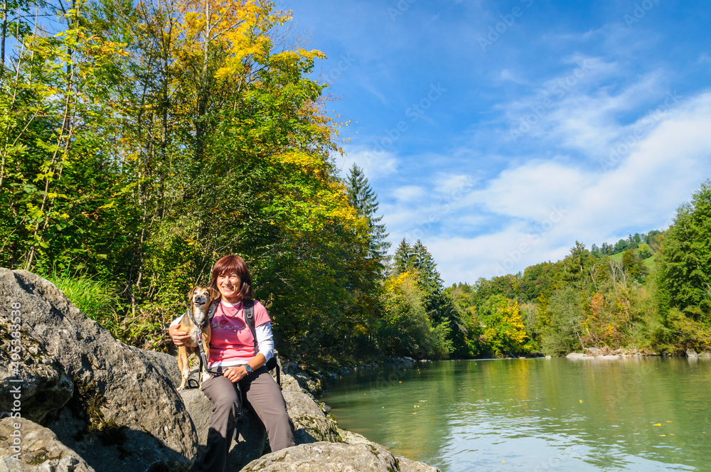 Auftanken am herbstlichen Flussufer bei einer Wanderung mit dem Hund Auftanken am herbstlichen Flussufer bei einer Wanderung mit dem Hund